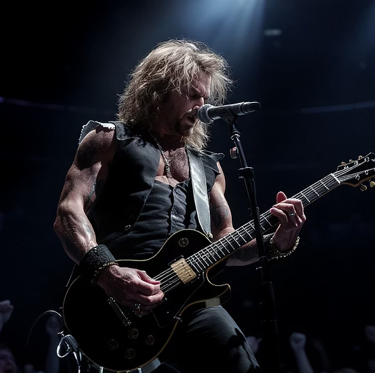 Rock guitarist on stage in a packed venue