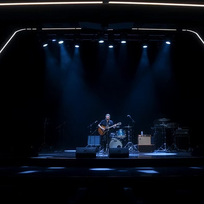 Solo musician on a stage under blue lights