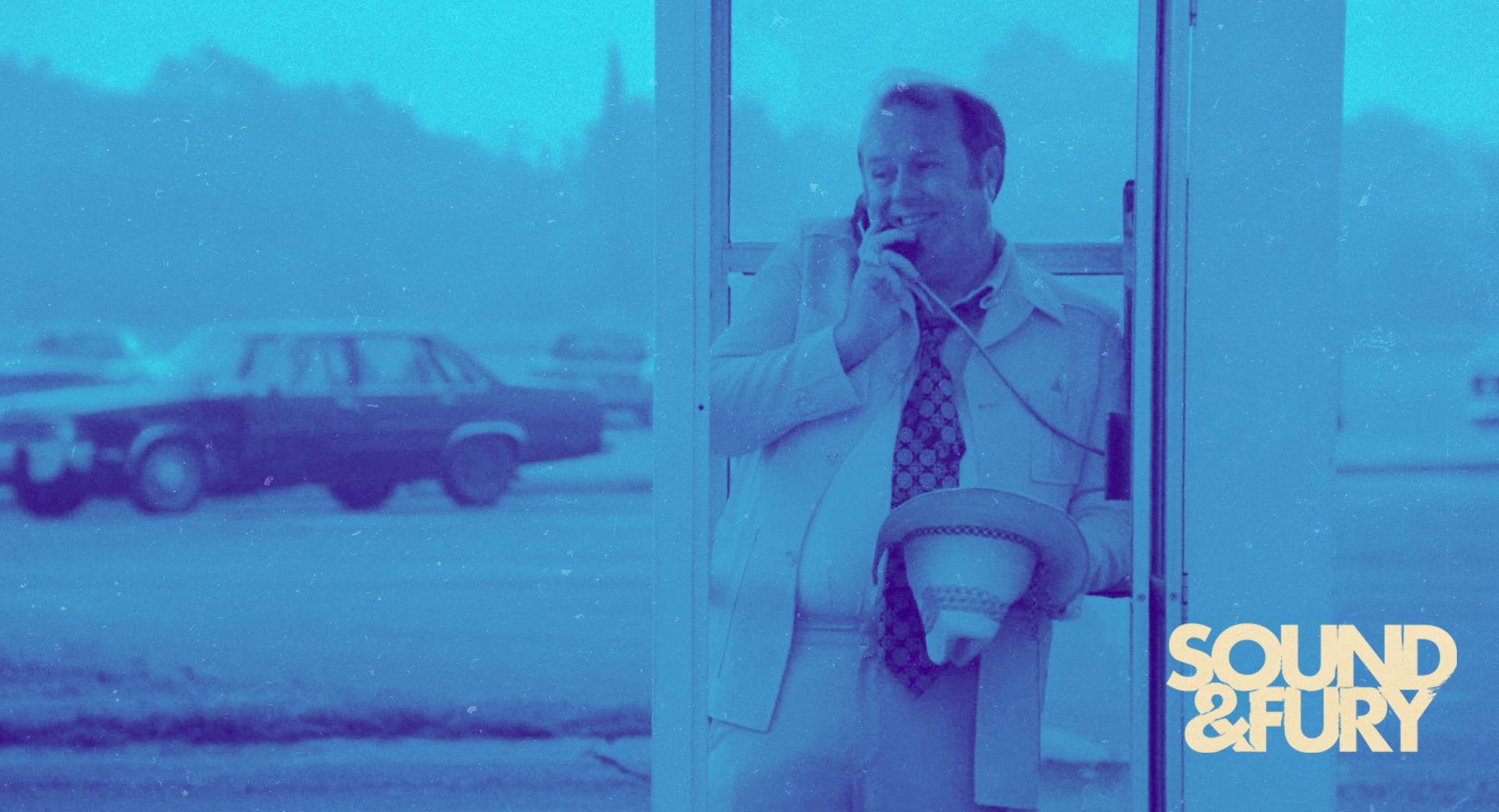 A man laughing on a payphone — the shady lawyer Hal